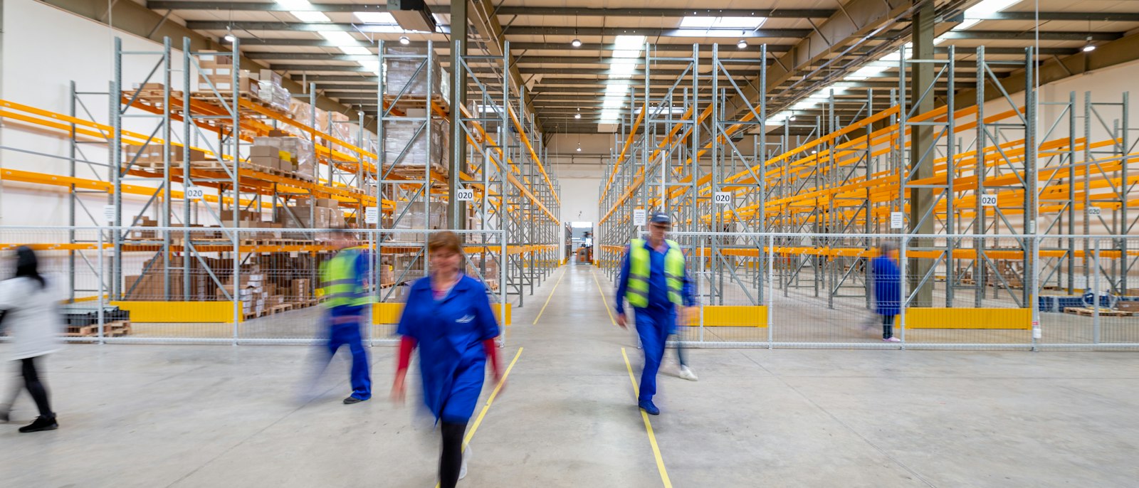 Workers moving through a distribution warehouse
